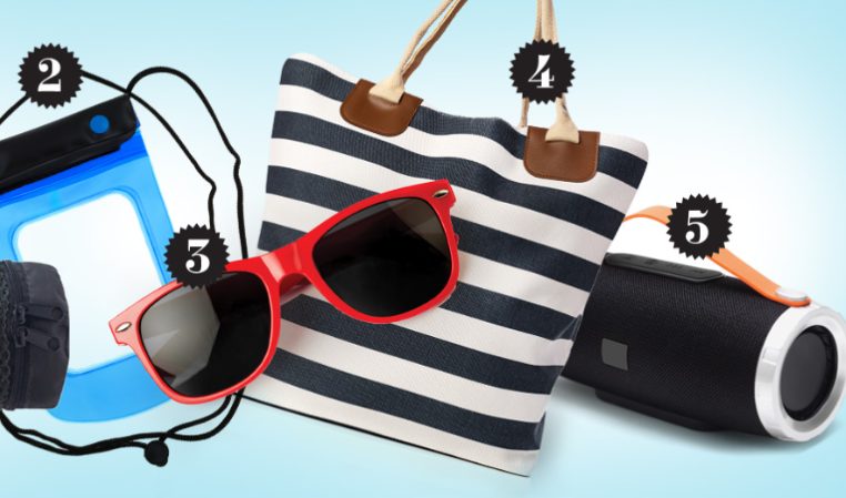 Five gift items on a light blue background: a green rolled up beach towel, blue waterproof phone pouch, red sunglasses, navy stripped bag, and black portable speaker.